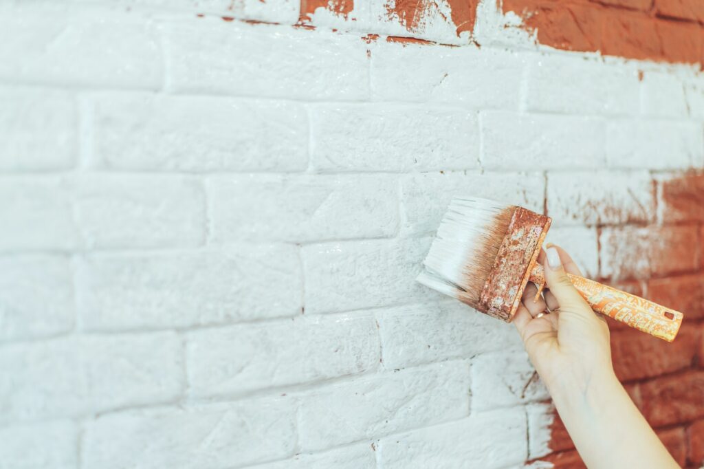 Paint brick wall white with brush